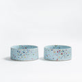 Two small blue ceramic dog bowls with a speckled pattern