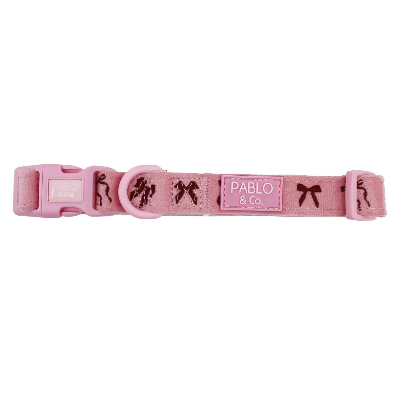 Pink dog collar with decorative elements and 'Pablo & Co.' label on a white background