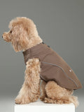 Dog wearing a brown vest