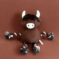 Brown plush dog toy with horns and rope handles on a brown background