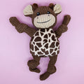 Stuffed dog toy with giraffe pattern on a pink background