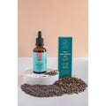 Pet Balance Oil bottle with dropper and packaging on a white surface with seeds around