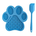 Blue paw-shaped lick mat with textured surface and a spatula