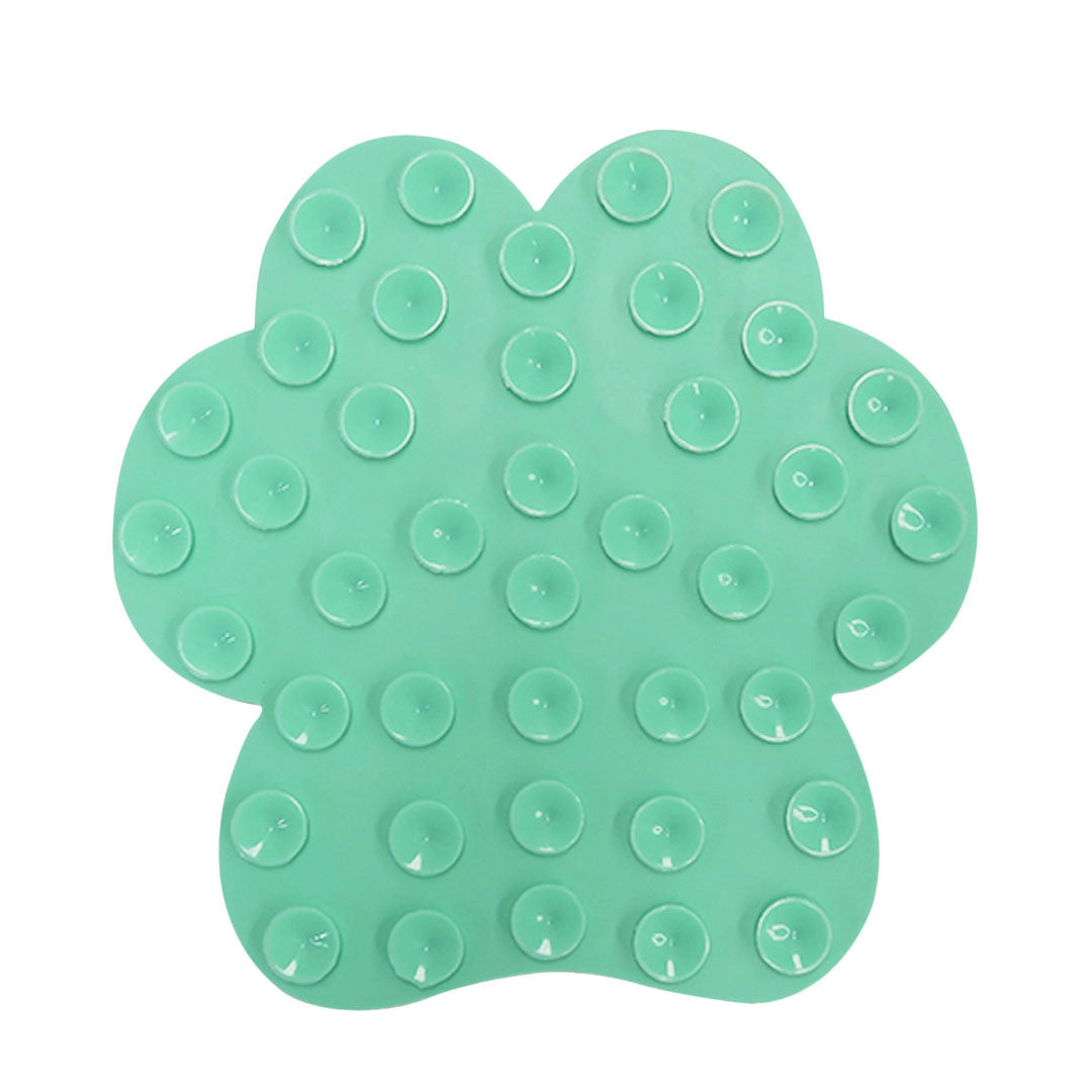 Green silicone lick mat with suction cups on a white background