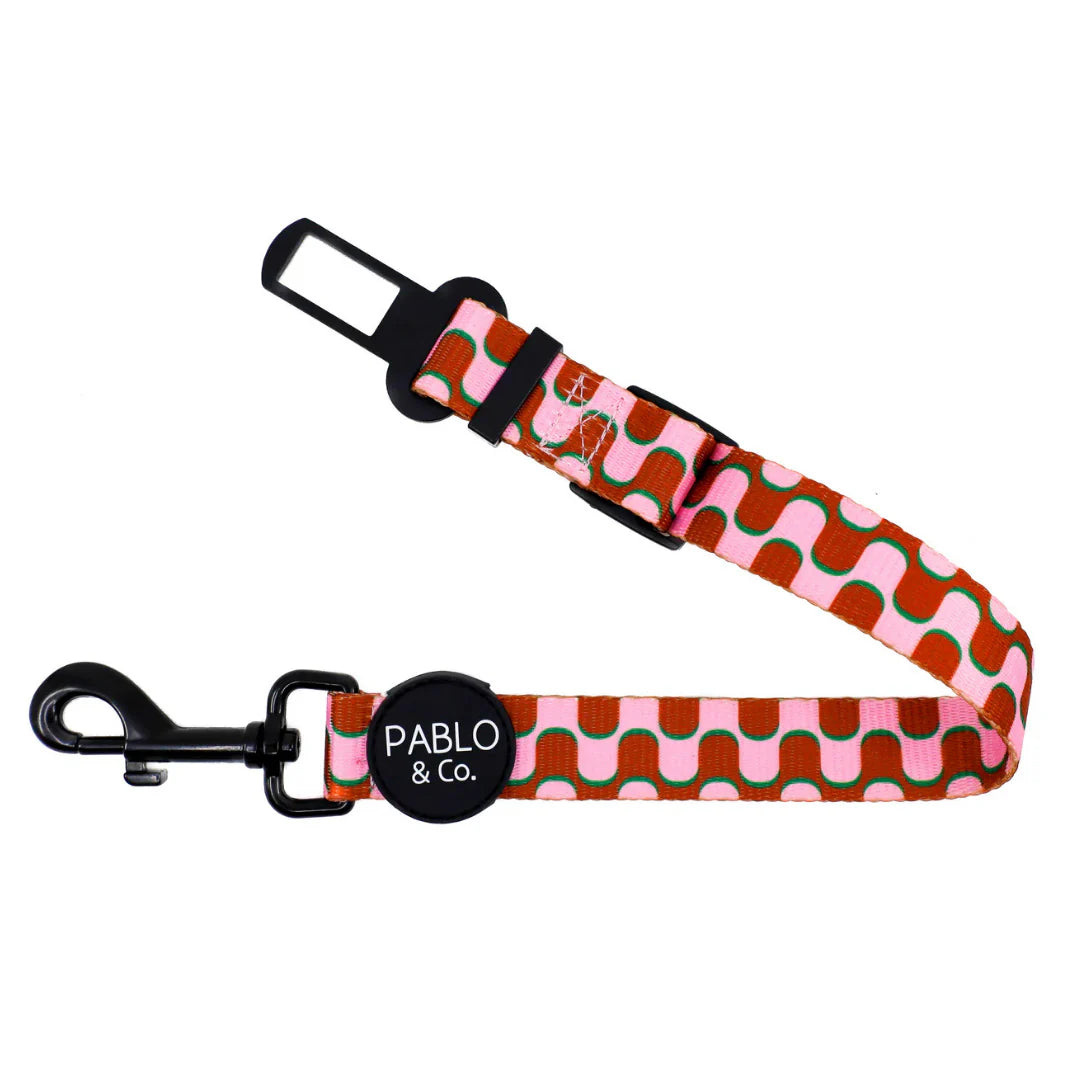 Dog car seat belt with pink pattern and 'Pablo & Co.' branding on a white background