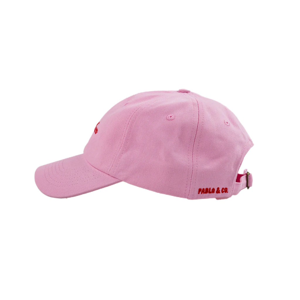 Pink cap with 'Pablo & Co' branding on a white background